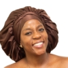 Woman wearing oversized chocolate brown satin bonnet designed for luxury overnight hair protection.