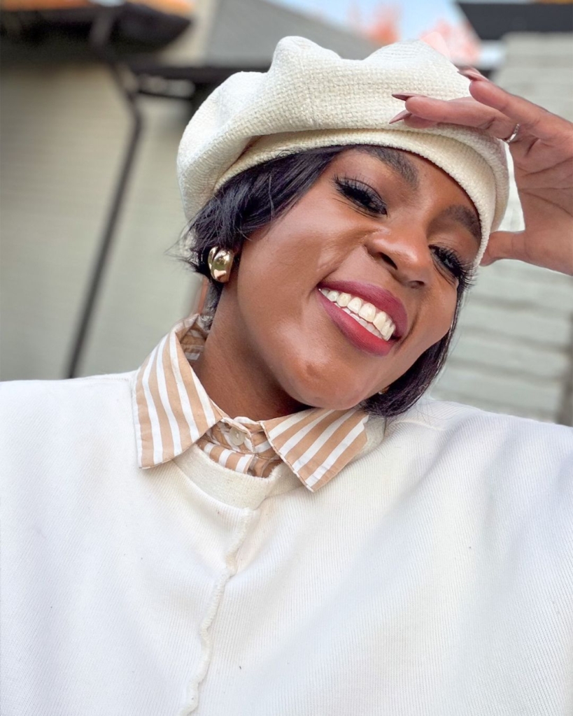 womn weainr textured cream bonnet, stripped shirt and knit top